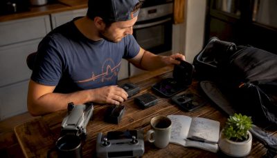 Man sorting drone gift accessories at home desk